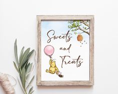 a winnie the pooh print hanging on a wall next to a potted plant