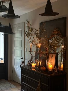 a room with candles and pictures on the wall