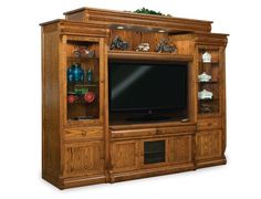 a wooden entertainment center with glass doors and shelves