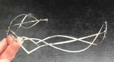 I have fabricated a sterling silver Celtic and Elvish inspired bridal tiara which is designed to be worn for a wedding, a Renaissance event, or hand-fasting ceremony. An artisan circlet with a Middle Earth feel! This piece can be unisex and comes without a gemstone. This piece will fit 3/4's around the head and is tied off, in the back, by an elastic jeweler's cord so that it will remain snug and in place while in motion. This works better than using a chain link, which can leave a circlet too t Elegant Adjustable Jewelry For Ceremonies, Silver Crown Headpiece For Wedding, Elegant Adjustable Silver Headpieces, Elegant Silver Headpiece With Teardrop Crown, Elegant Silver Teardrop Crown Headpiece, Elegant Silver Headpieces For Gifts, Elegant Silver Crown Headband, Elegant Silver Headband For Wedding, Elegant Teardrop Crown Headpiece For Gifts