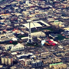 an aerial view of a city with tall buildings and a space needle in the center