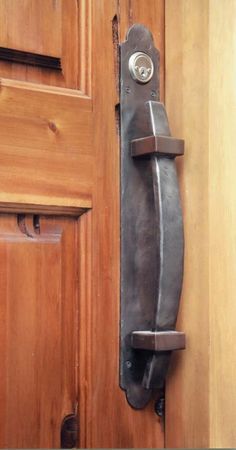 an old door handle on a wooden door