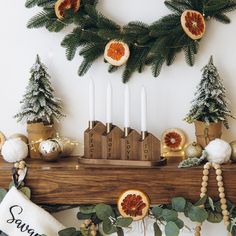 a christmas mantle with candles, figurines and decorations