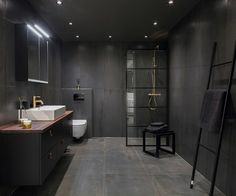 a bathroom with a sink, toilet and shower stall in the middle of the room