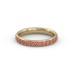 a yellow gold band with pink sapphire stones