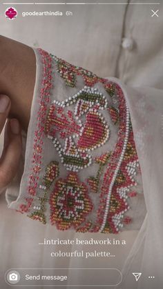 a woman's hand with beaded bracelet on it