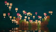 many paper lanterns floating in the air over water