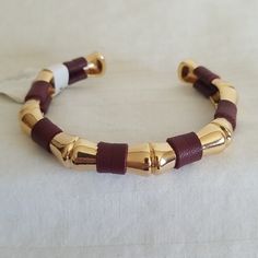 Gold Tone. Dark Red. Trendy Gold Leather Bracelet, Chic Adjustable Leather Bracelet, Elegant Brown Leather Bracelet For Party, Elegant Brown Metal Cuff Bracelet, Adjustable Burgundy Bracelets, Trendy Leather Cuff Bracelet, Trendy Red Adjustable Leather Bracelet, Chic Brown Bracelet Jewelry, Elegant Red Leather Bracelets