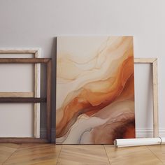 an abstract painting on the wall next to a wooden frame with a roll of paint