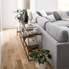 a living room with white walls and wooden floors