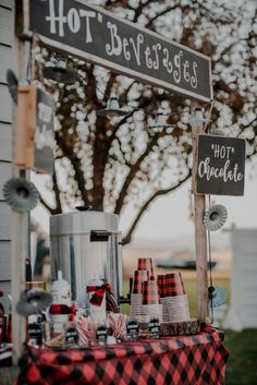 a red and black checkered table cloth with hot chocolate on it next to a street sign