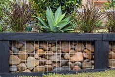 there is a planter with rocks in it