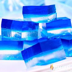 blue ice cubes sitting on top of a white plate