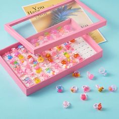 a pink box filled with lots of little beads