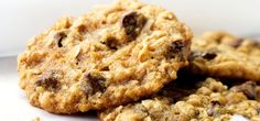 three oatmeal chocolate chip cookies sitting on top of each other in a pile