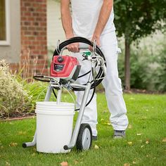 a man standing next to a lawn mower