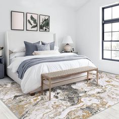 a bedroom with a large bed and white walls