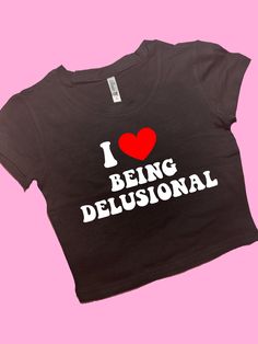 I Love Being Delusional SNUG FIT Crop Top | Cute Crop Top | Graphic Top | Gift For Her | Y2K Baby Tee | Y2K crop top | Gift for friend Comfy Top to Lounge in! Actual item may be lighter/darker than pictured. M A T E R I A L S - SNUG FIT - 100% RING SPUN COTTON - Shoulder Taping S I Z I N G - Size chart is available on our listing photos. S H I P P I N G  &  P R O D U C T I O N  T I M E - Production Time is 2-3 Business Days. (May be delayed during the Holiday Season) - Shipping Time is 2-5 Busin Custom Crop Top, Stylish Crop Top, Trendy Crop Tops, Y2k Crop Top, Graphic Crop Top, Cute Crop Top, Baby Tees Y2k, Y2k Baby Tee, Y2k Clothing