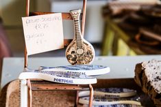 a small wooden instrument sitting on top of a chair next to bread and other items