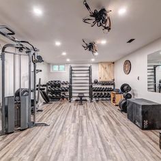 a home gym with equipment and mirrors