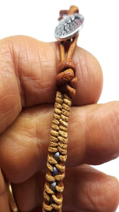 a person is holding a small piece of string