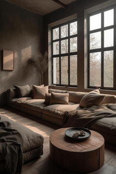 Organic Wabi-Sabi Elegance in Exquisite Living Room Interiors Cozy Living Room Aesthetic Comfy, Low Living Room Seating, Dark Wabi Sabi Interior, Wabi Sabi Library, Axel Vervoordt Living Room, Wabi Sabi Grey Couch, Relaxing Living Room Ideas, Wabi Sabi Window, Dark Wabi Sabi