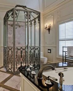 a large bathroom with a walk in shower next to a sink and bathtub area