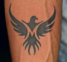 a man with a tattoo on his arm that has a bird design on the side