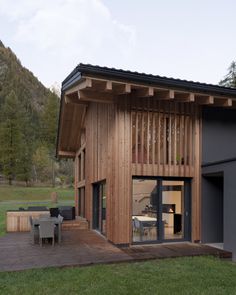 a modern house with wood siding and glass doors