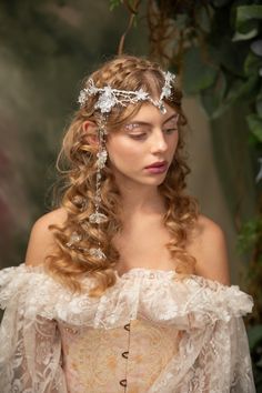 Romantic wedding tiara in winter frozen design :) Perfect for renaissance festivals, parties, weddings, photoshoots, Halloween, carnivals, ... The tiara is made of artificial flowers, beads and other arranging material. It's also possible to purchase a veil that can be attached to the tiara Model: Ester Photo: Michaela durisova photography When stored in dry and dark place, our products last 10-15 years. We can also make you other matching accessories. Please message me for more information. :) ---------------------------------------------------------------- SHIPPING INFO FOR EU ORDERS: Standard shipping: Your package will arrive in about 5-8 days after it has been shipped.  Express shipping: Your package will arrive in about 1-3 days after it has been shipped.  FOR INTERNATIONAL ORDERS: W Veil Transparent, Tiara With Veil, Bridal Diadem, Wedding Crown Veil, Frozen Design, Flower Crown Veil, Elven Tiara, Festival Crown, Short Wedding Gowns