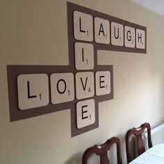 the wall is decorated with scrabble tiles that spell out love, laugh and laugh