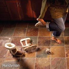 a person standing on top of a kitchen floor