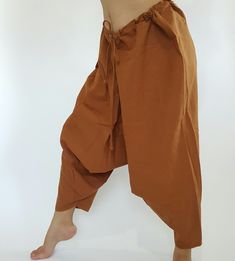 "⬇️ SHOP HERE https://www.etsy.com/ch-en/shop/IndycraftsDesigns Aladdin Pants, Harem Pants 100% Cotton Unisex pants, perfect for yoga, The fabric is cotton soft, lightweight, and airy, ideal for those warm days. If it's a bit chilly, you could always wear leggings underneath. super comfortable cotton pants made of light, comfortable to wear 100% cotton. Cotton is a natural material that wicks moisture to keep you cool, comfy & dry. Floral printed, elastic waistband,medium-weight, Soft and Co Brown Harem Pants With Pockets, Brown Harem Bottoms With Pockets, Baggy Brown Harem Bottoms, Brown Harem Bottoms For Yoga, Baggy Brown Festival Pants, Brown Baggy Pants For Festival, Traditional Brown Harem Pants, Brown Baggy Bottoms For Festival, Traditional Brown Cotton Bottoms