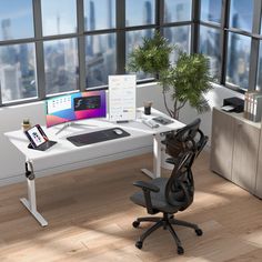 a computer desk with a laptop and monitor on it in an office space overlooking the city