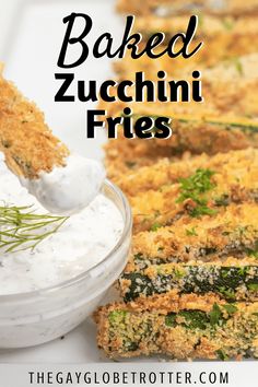 baked zucchini fries in a bowl with sour cream and herbs on the side