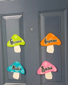 the door is decorated with magnets to spell out their name, and three mushrooms are on each side