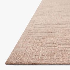 a beige rug on a white background with no one in it or someone out front