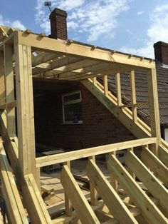 a house being built with wooden framing