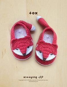 a pair of crocheted baby shoes with a fox face