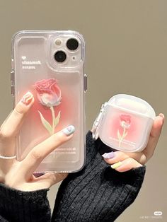 a woman holding up her phone case with a flower on the front and bottom cover