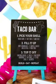 a sign that says taco bar on it next to some other things in the background