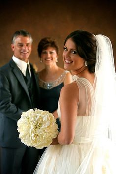 the bride and groom are posing for a photo