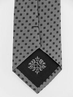 "Mens classic silver and black 100% silk necktie. Features a sliver background with small black squares. Available as a extra long necktie. Handmade from 100% silk, this special collection features a .75\" Eds Neckties logo at the bottom right front corner of every tie and a larger logo located on the tipping (Back of the tie). The label features the collection name (Nathaniel Alexandria) Named after my son Nathaniel and my daughter Alexandria. Expertly hand-made from 100% silk you can select yo Silver Tie For Formal Occasions, Silver Tie For Father's Day Formal Wear, Silver Tie For Formal Occasions And Father's Day, Father's Day Silver Suit And Tie Accessories, Elegant Ties For Black Tie Events And Father's Day, Elegant Black Tie For Father's Day, Classic Rectangular Ties For Business, Standard Tie For Black Tie Occasions And Father's Day, Black Tie Occasion Ties For Father's Day