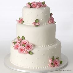 a three tiered cake with pink flowers on it's side and the words contour cakes written below