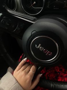 a woman is holding the steering wheel on her car