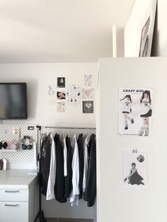 a white refrigerator freezer sitting in a kitchen next to a wall with pictures on it