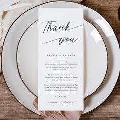 a table setting with white plates and silverware, napkins and utensils