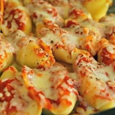 some pasta shells with sauce and cheese on them