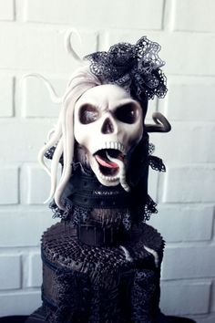 a cake that has been decorated to look like a skeleton with hair and makeup on it