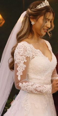 a woman in a wedding dress looking at her cell phone